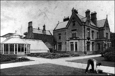 Old Photograph showing someone attending the gardens outside Ryecroft Hall