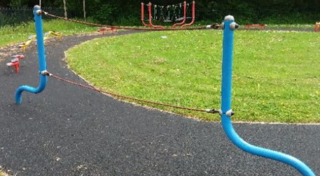 Four flat seat swings situated on wetpour
