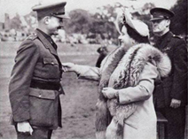 Her majesty decorating Major Tod with the MC