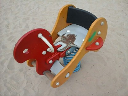 Four cradle seat swings situated on wetpour