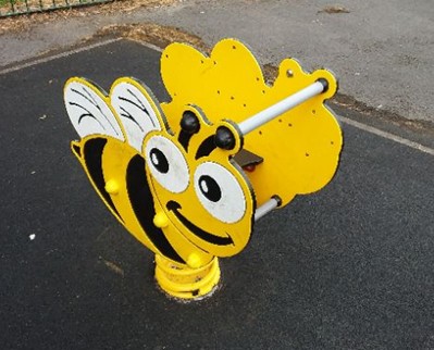 Multi-play unit including climbing board, netted climbing rope, balance beem and seats situated on wetpour
