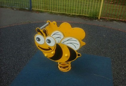 Multi-play unit with wooden step access and metal slide situated on sand