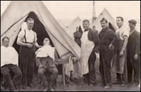 Men of the 1/10th Battalion the Manchester Regiment in camp, believed to be somewhere in France. The barber is Private Greenhalgh (MRP/4/E)